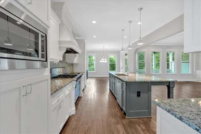 a kitchen with stainless steel appliances granite countertop a stove oven and refrigerator