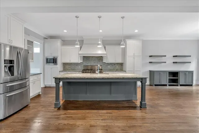 a view of a kitchen with a sink stainless steel appliances and cabinets