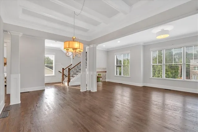 a kitchen with granite countertop a stove and a wooden floor