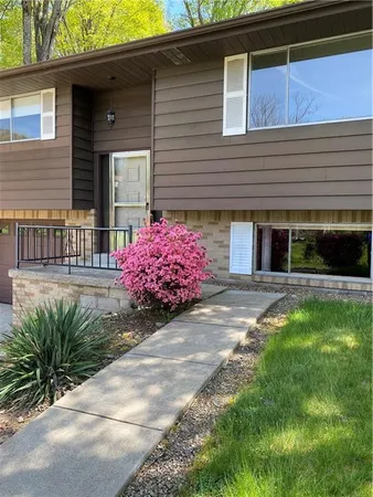 a front view of a house with garden