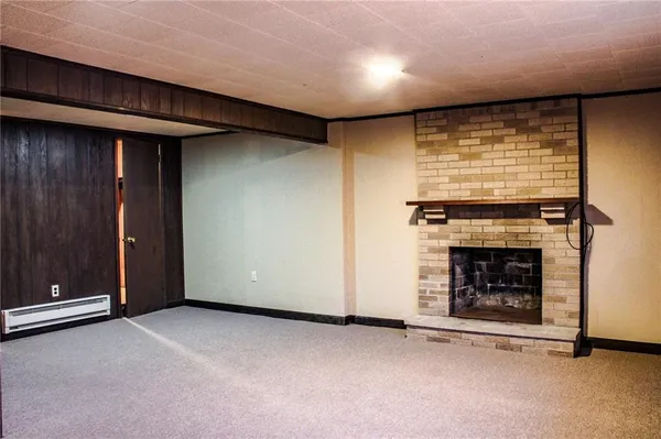 a view of an empty room with a fireplace