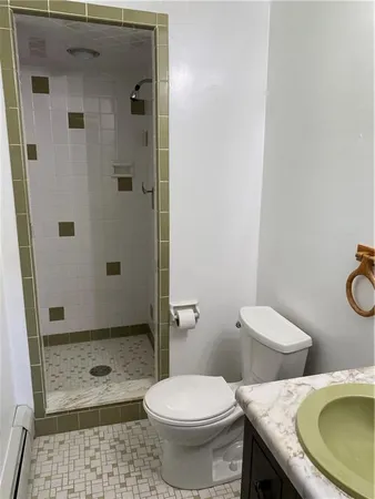 a white toilet sitting next to a bathroom sink