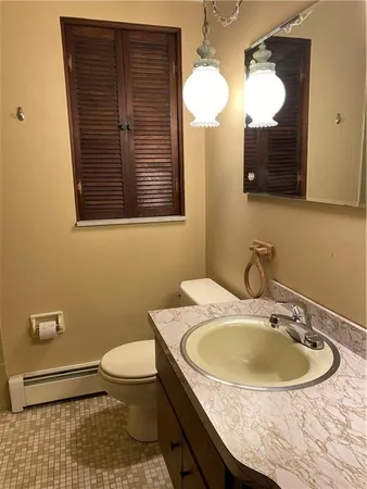 a bathroom with a sink a toilet and mirror