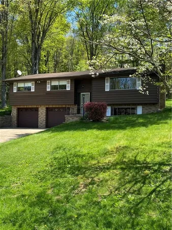 a view of house with yard