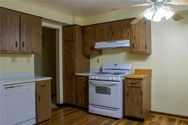 a kitchen with stainless steel appliances granite countertop a stove and a refrigerator