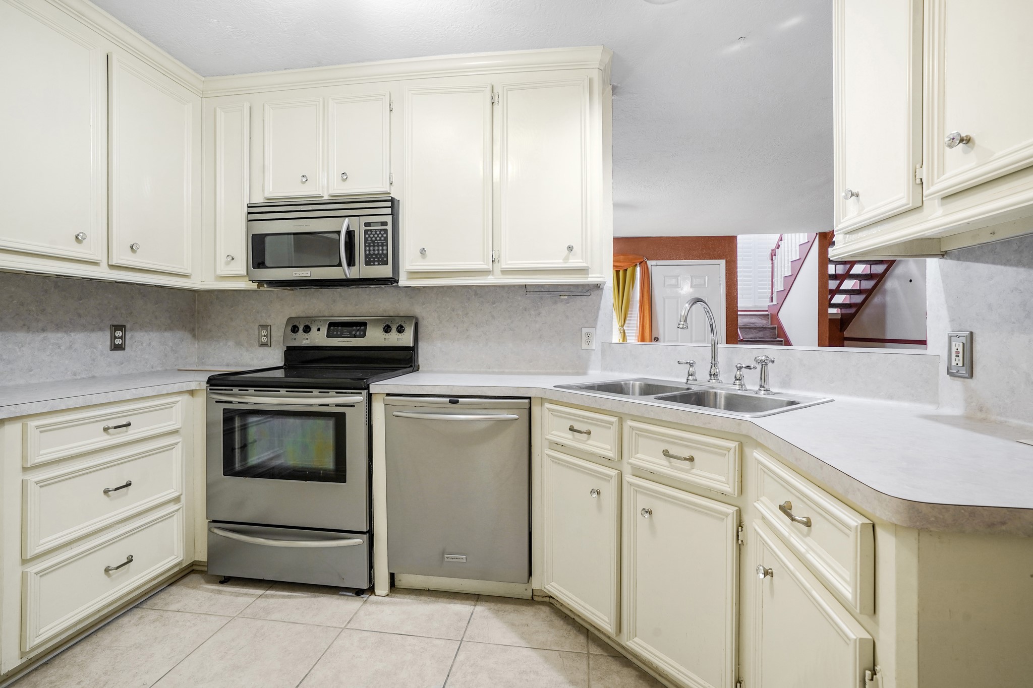 50 Evanston Street, Unit 3 Houston, TX 77015 - Photo 8 of 21 a kitchen with cabinets stainless steel appliances and a sink