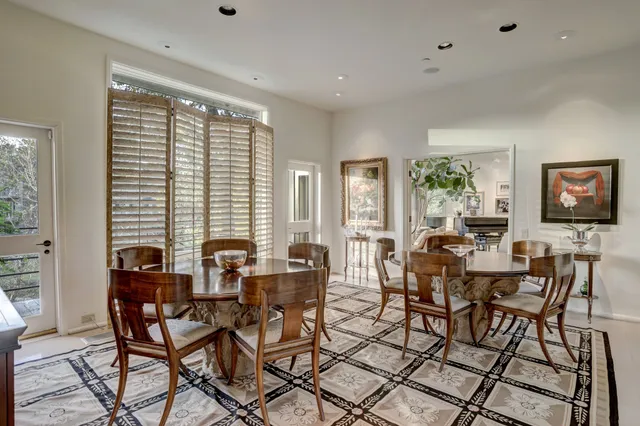 a view of a dining room with furniture large windows and wooden floor