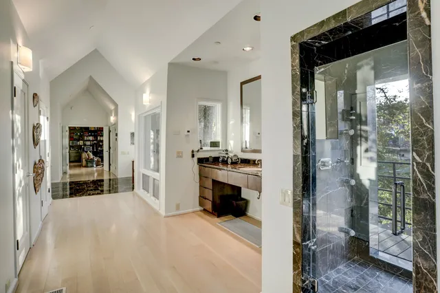 a view of a bathroom with a tub shower and mirror