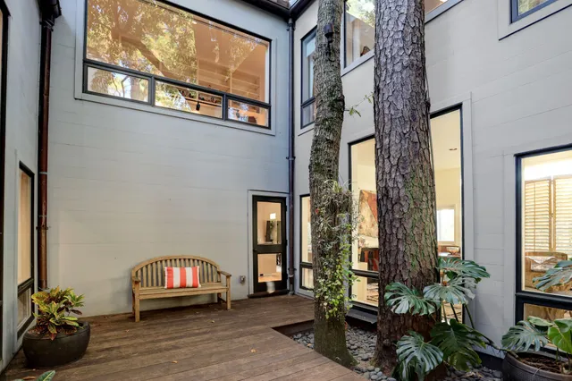 a view of front door with potted plants