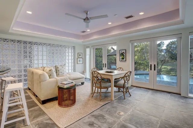 a very nice looking dining room with a table and a large mirror