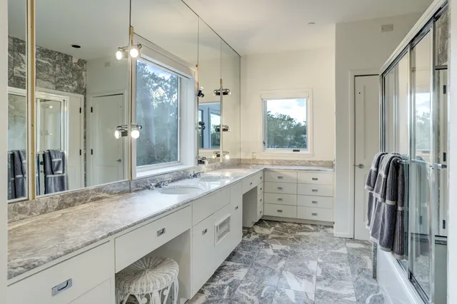 a bedroom with furniture and a large window