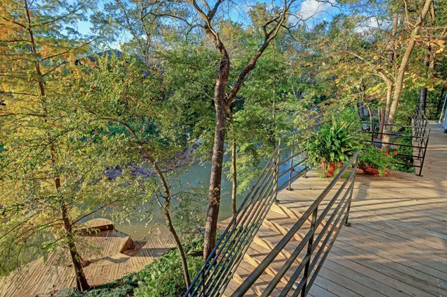 a view of a balcony with wooden floor and outdoor space