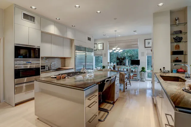 a kitchen with stainless steel appliances granite countertop a stove and a sink