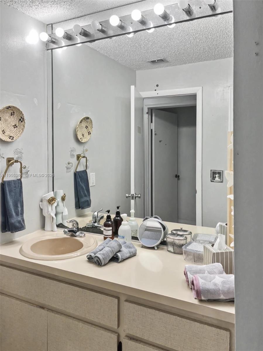 1712 Southwest 13th Street Miami, FL 33145 - Photo 41 of 44 a bathroom with a sink and a mirror