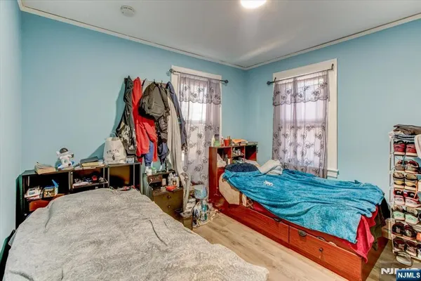 a bed sitting in a bedroom next to a window