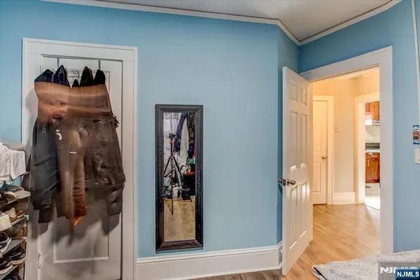 a view of a hallway with closet and a window