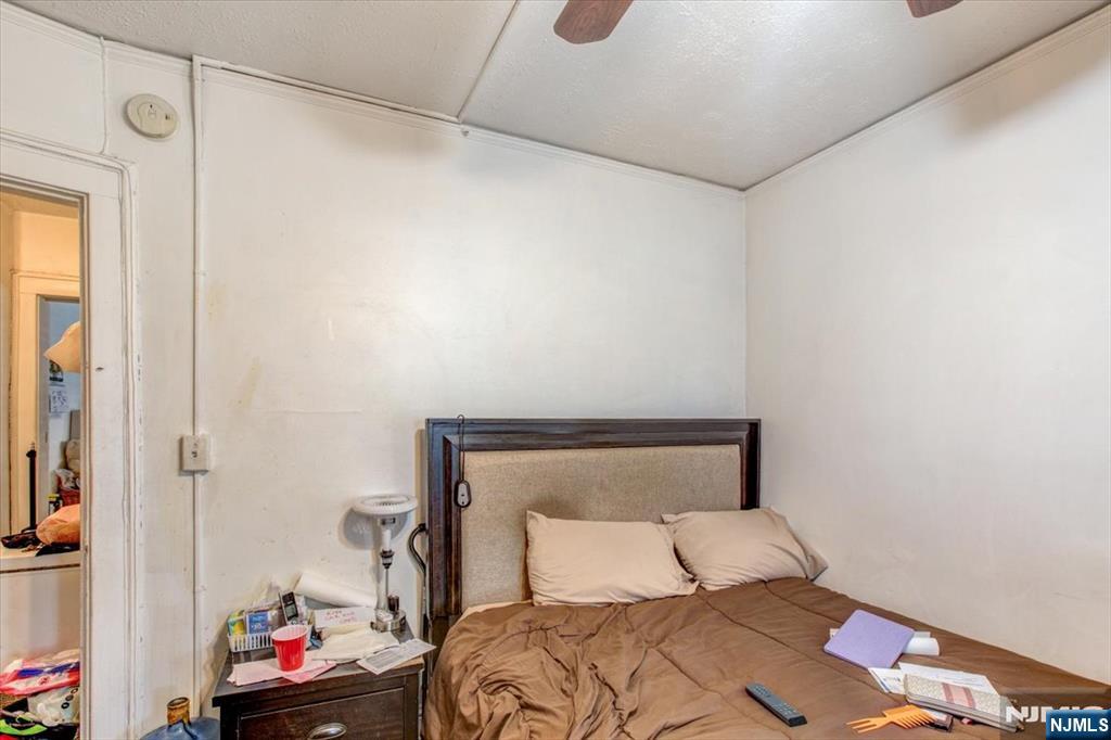 162 Summer Street Orange, NJ 07050 - Photo 19 of 29 a bedroom with a bed and wooden floor