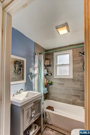 a bathroom with a sink a bathtub and a shower