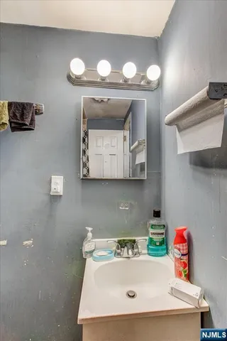 a bathroom with a sink vanity and mirror