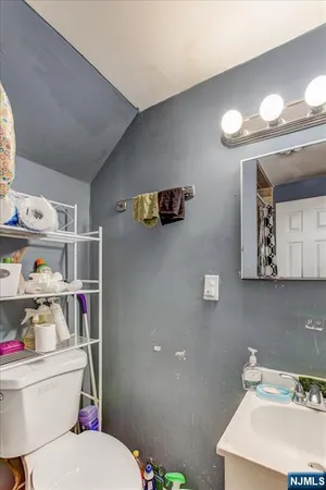 a bathroom with a toilet a sink and a mirror