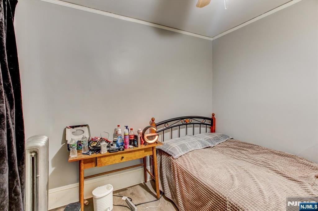 162 Summer Street Orange, NJ 07050 - Photo 10 of 29 a bedroom with a bed and a table in it