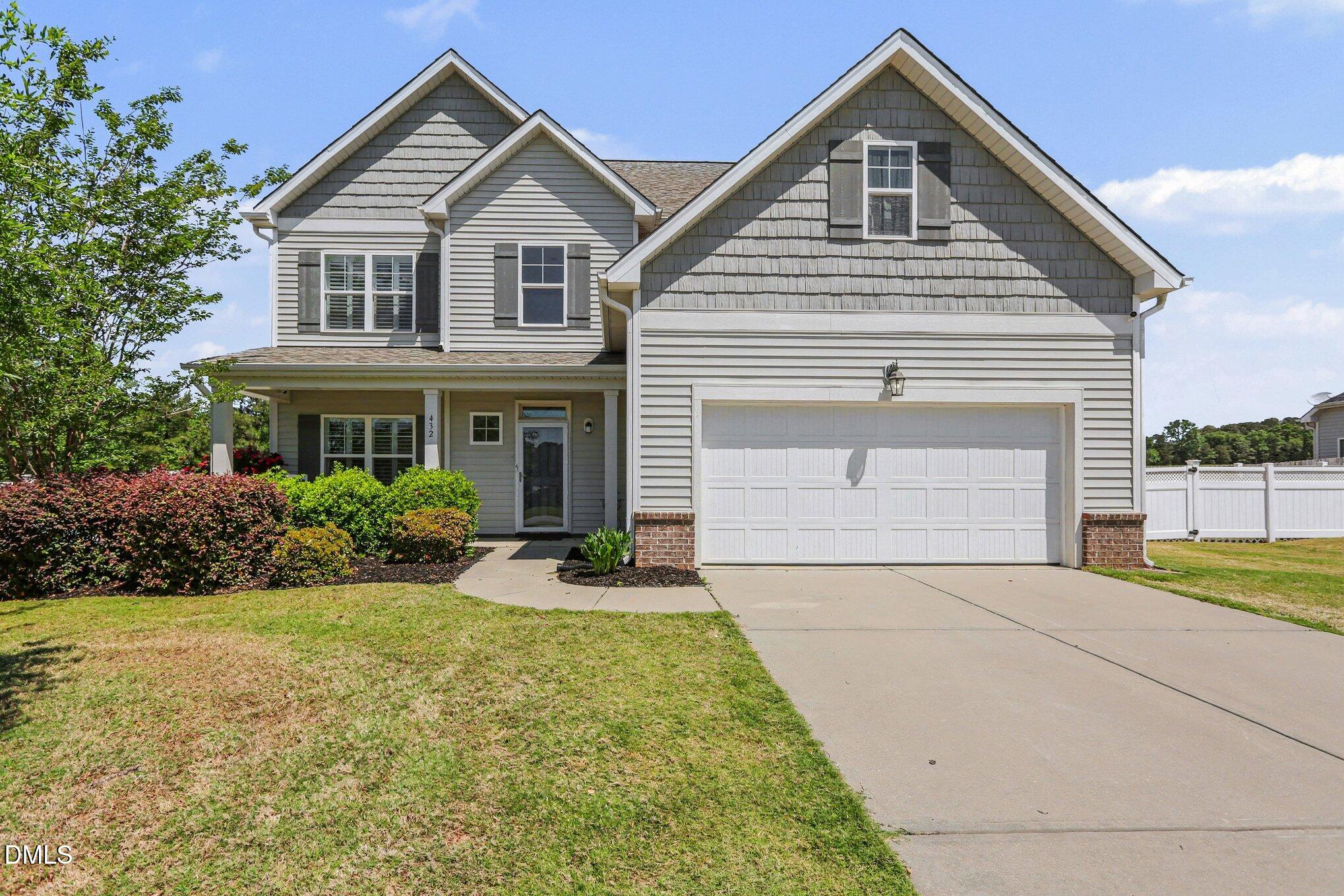 432 Seabring Lane Raleigh, NC 27603 - Photo 3 of 29 a front view of a house with a yard and garage
