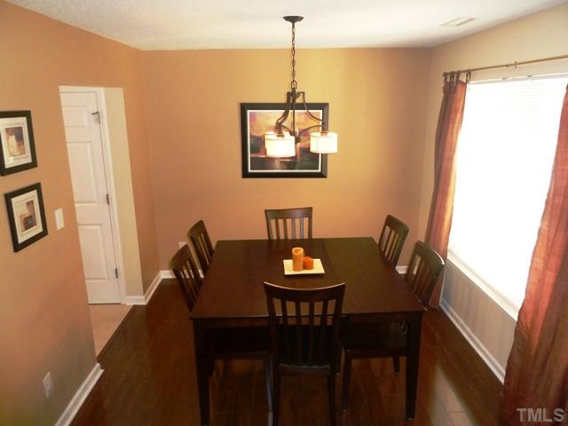 4112 Hopper Street Raleigh, NC 27616 - Photo 3 of 25 a view of a dining room with furniture and wooden floor