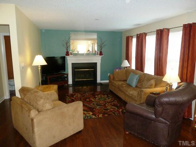 4112 Hopper Street Raleigh, NC 27616 - Photo 4 of 25 a living room with furniture and a fireplace