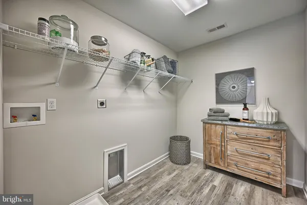 a kitchen with stainless steel appliances granite countertop a sink a stove and a white cabinets