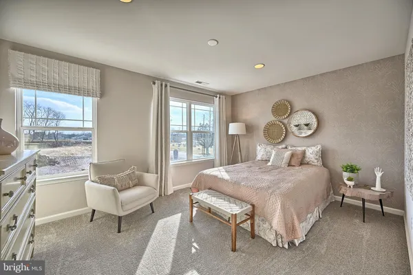 a bedroom with furniture and flowerpot