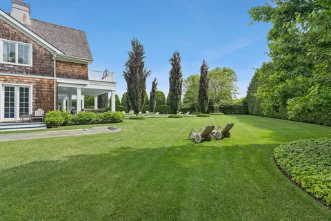 a view of a house with a backyard and a garden