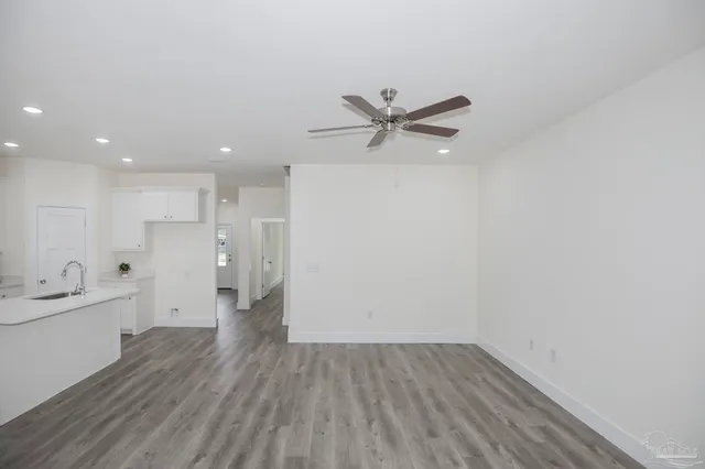 a view of a kitchen with a sink and wooden floor