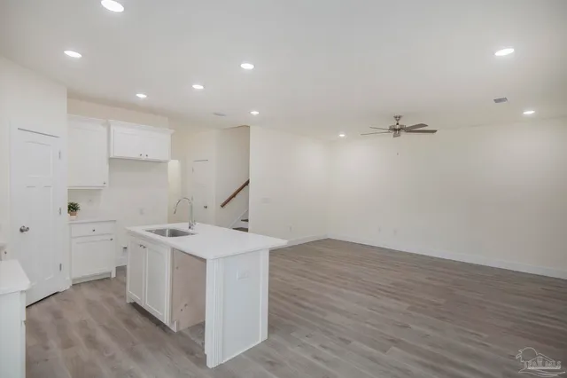 a kitchen with a sink stainless steel appliances and cabinets