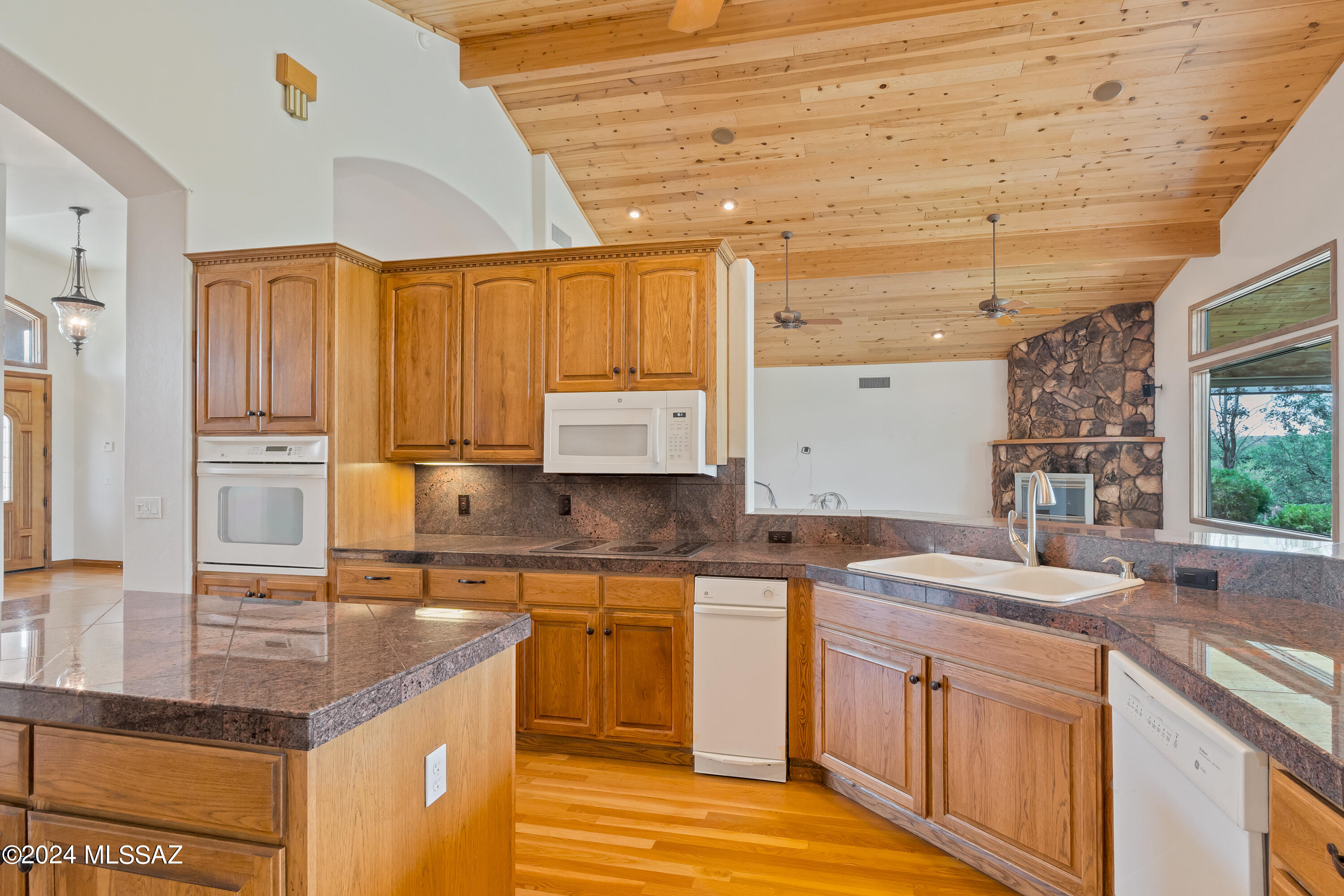 4001 North Harrison Road Tucson, AZ 85749 - Photo 13 of 50 a kitchen with a sink stove and cabinets