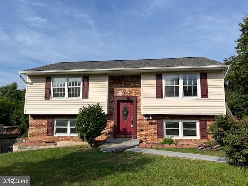 10310 Meadowview Drive Fredericksburg, VA 22408 - Photo 1 of 25 a front view of a house with a yard and garage