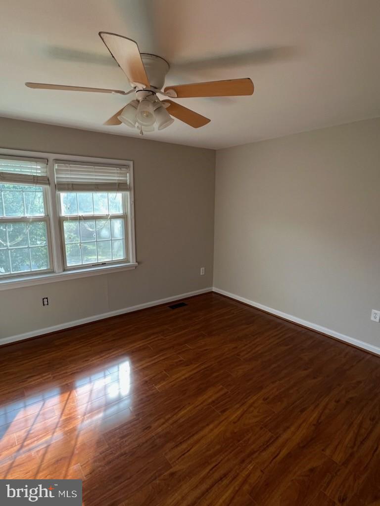 10310 Meadowview Drive Fredericksburg, VA 22408 - Photo 16 of 25 a view of an empty room with wooden floor and a window