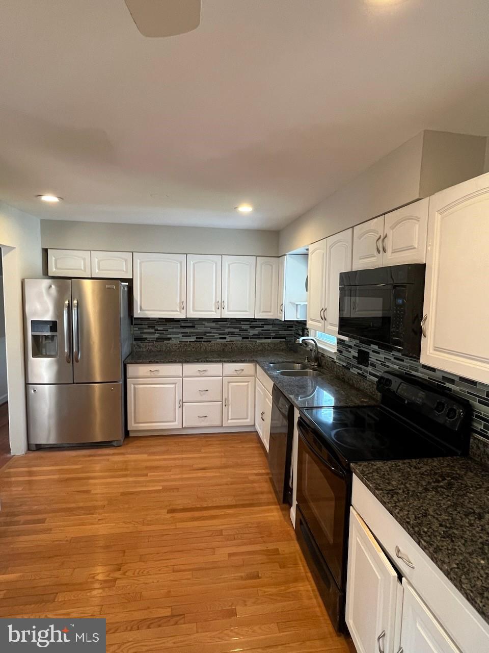10310 Meadowview Drive Fredericksburg, VA 22408 - Photo 6 of 25 a large kitchen with stainless steel appliances granite countertop a stove a sink and a refrigerator