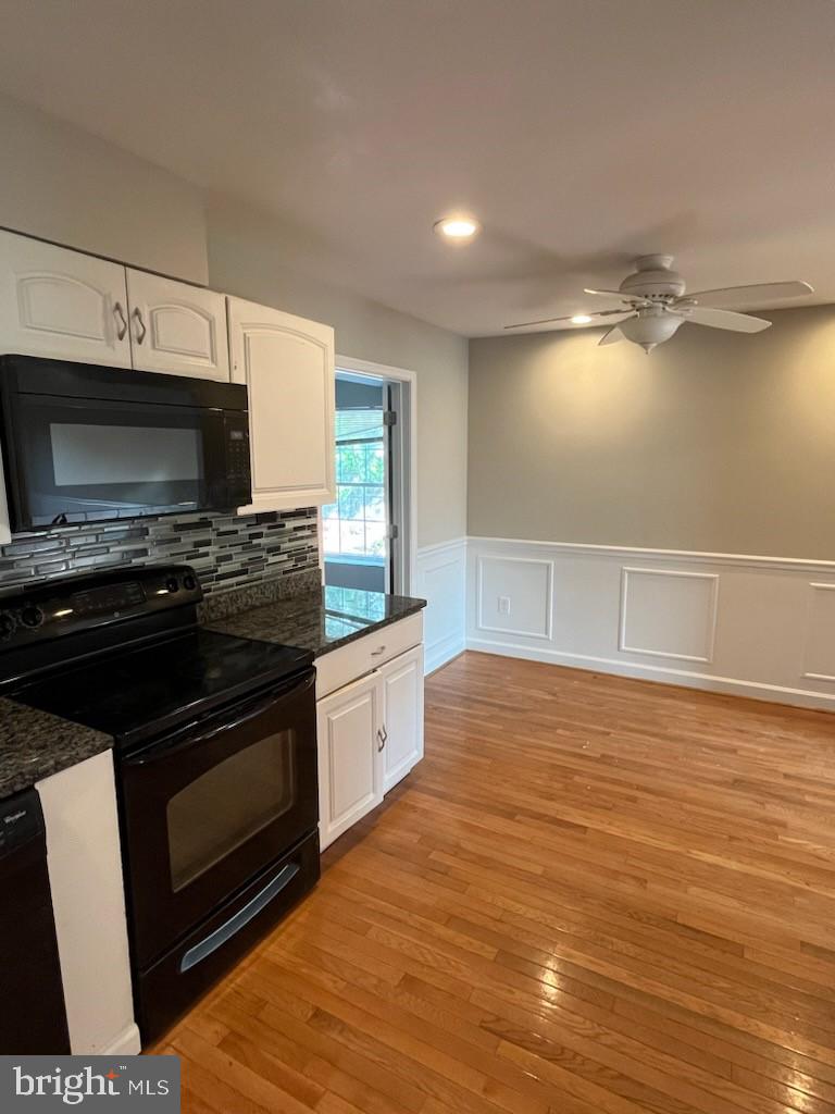 10310 Meadowview Drive Fredericksburg, VA 22408 - Photo 7 of 25 a kitchen with stainless steel appliances a stove a microwave and sink