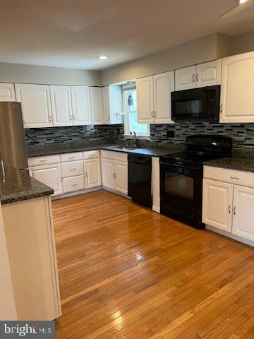 10310 Meadowview Drive Fredericksburg, VA 22408 - Photo 8 of 25 a kitchen with granite countertop stainless steel appliances and white cabinets