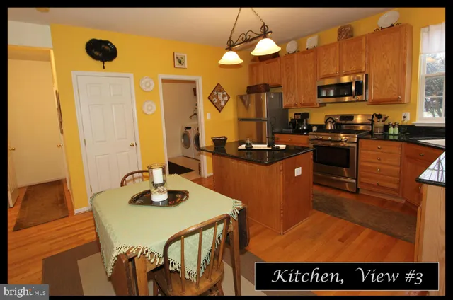 a view of a dining room with furniture and a chandelier