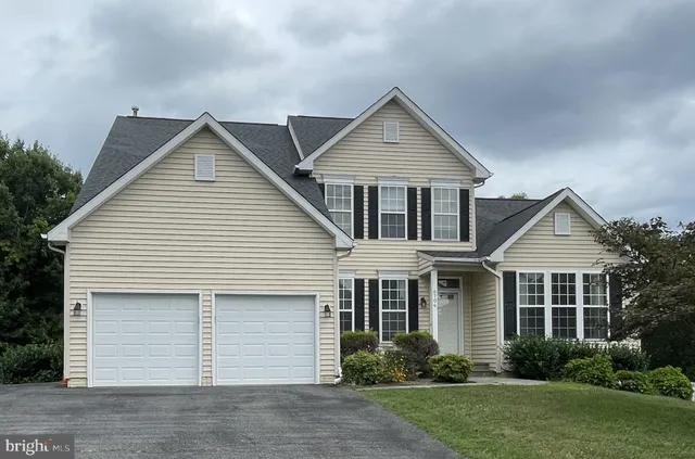a view of a house with a yard and sitting area