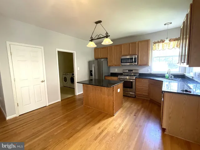 wooden floor in an empty room with a fireplace