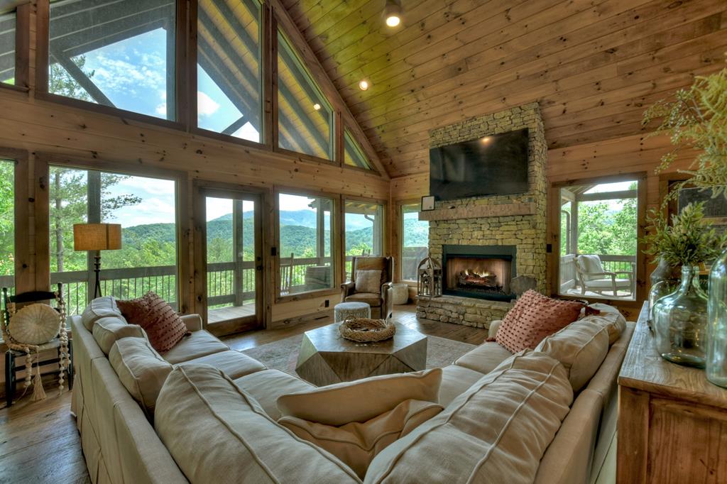 401 Foster Cove Road Epworth, GA 30541 - Photo 1 of 51 a living room with furniture a fireplace and a floor to ceiling window