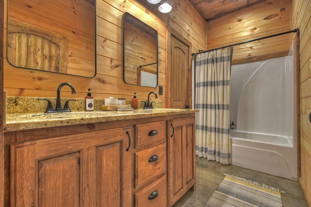 401 Foster Cove Road Epworth, GA 30541 - Photo 18 of 51 a bathroom with a granite countertop sink and a mirror