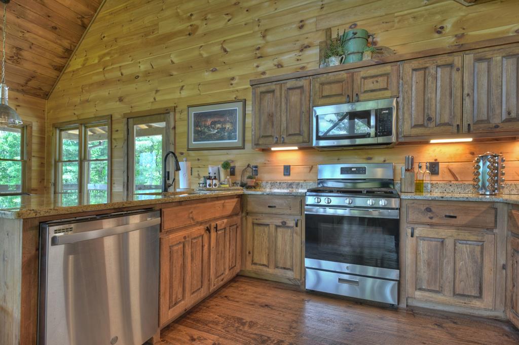 401 Foster Cove Road Epworth, GA 30541 - Photo 29 of 51 a kitchen with stainless steel appliances granite countertop a stove and a sink