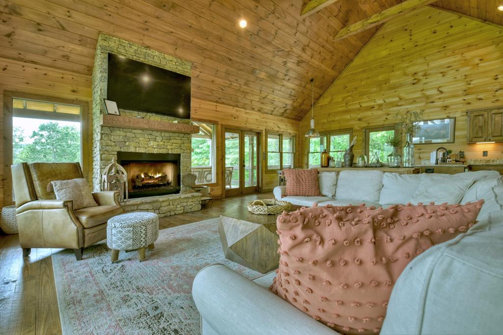 401 Foster Cove Road Epworth, GA 30541 - Photo 30 of 51 a living room with furniture a flat screen tv and a fireplace