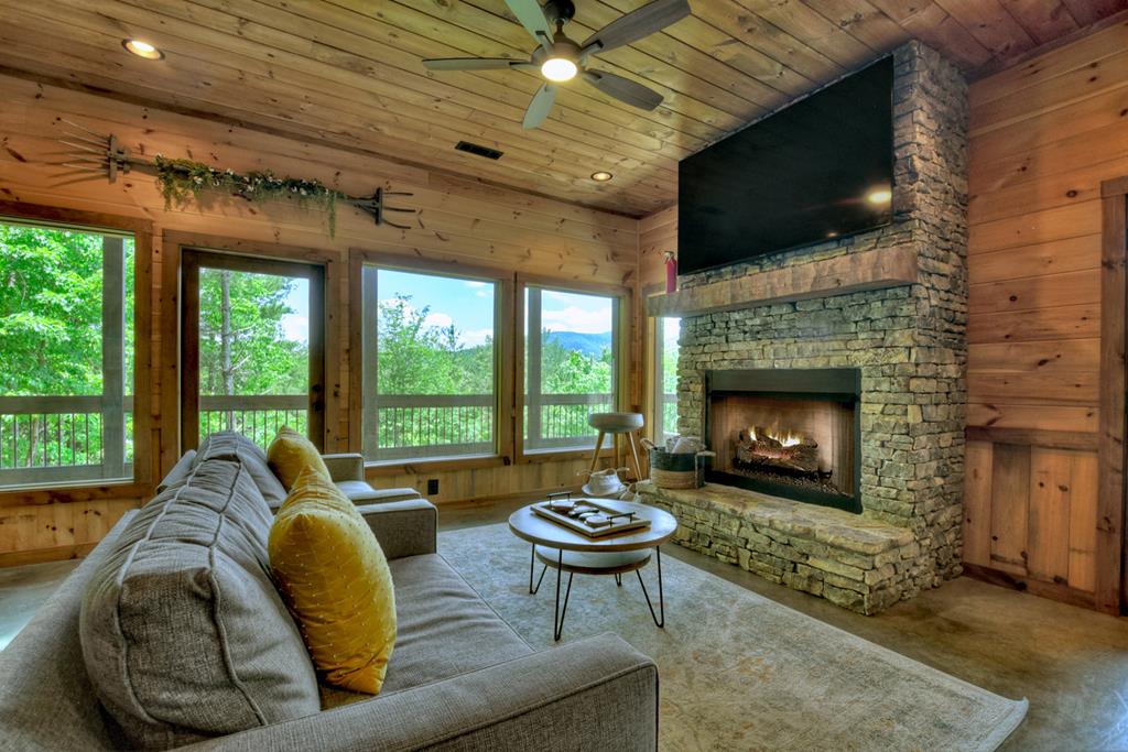 401 Foster Cove Road Epworth, GA 30541 - Photo 10 of 51 a living room with furniture a fireplace and a flat screen tv