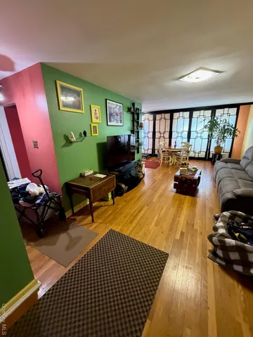 a room with furniture or wooden floor and a large window