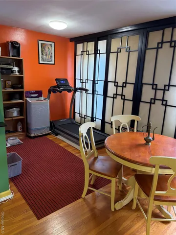 a dining room with furniture a rug and wooden floor