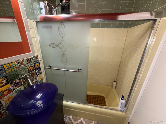 a bathroom with a sink and shower